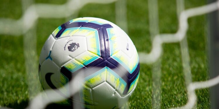 A football ball in a netDescription automatically generated